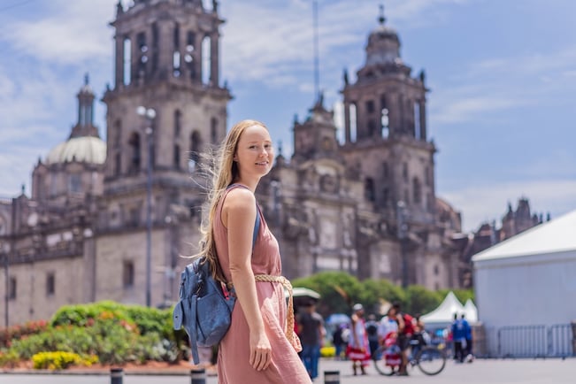 Tourist standing in front of the Metropolitan Cathedral in Mexico City