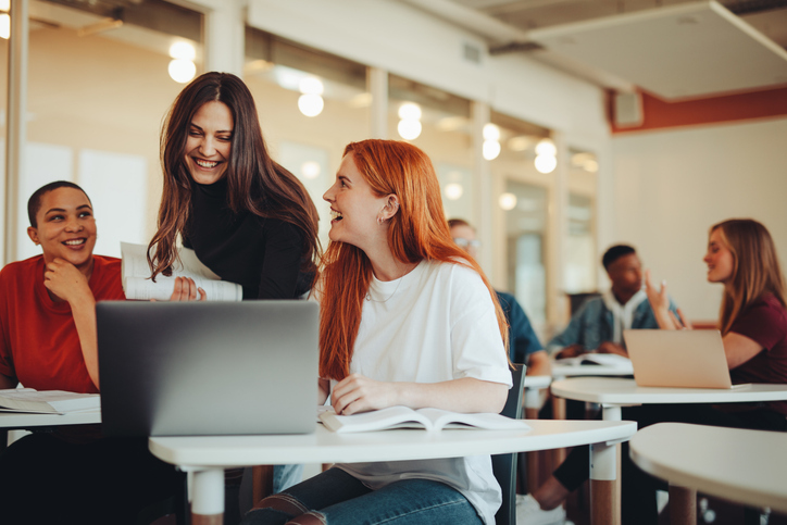 Instructor helping two adults students in an English class.
